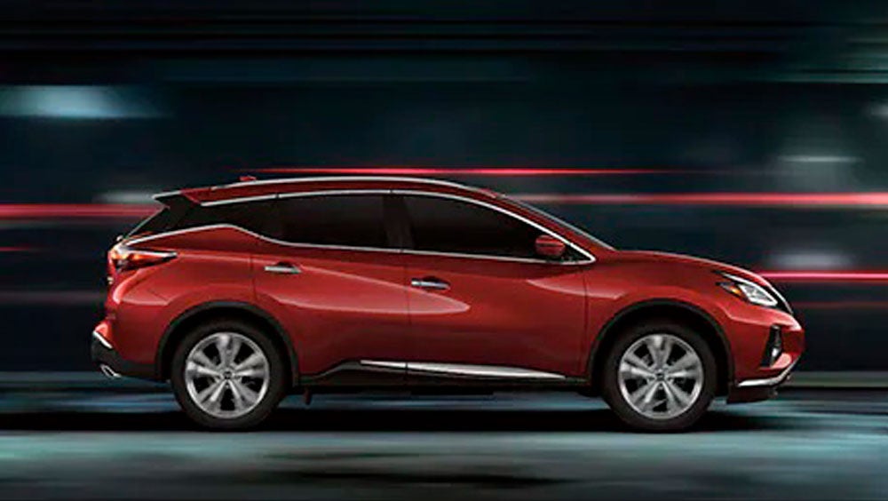 2023 Nissan Murano shown in profile driving down a street at night illustrating performance. | Rolling Hills Nissan in Saint Joseph MO